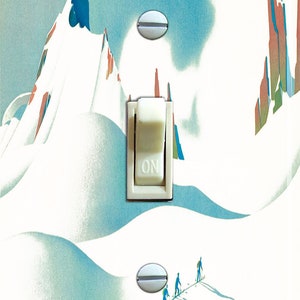 May include: A light switch cover featuring a vintage illustration of skiers on a snowy mountain. The switch is in the "ON" position.