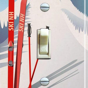 May include: A light switch cover featuring a vintage ski scene. The cover depicts two red skis with the words "SKI NH" on them, two red ski poles, and a mountain scene in the background. The text "FRANCONIA NOTCH, NEW HAMPSHIRE" is at the bottom of the cover.