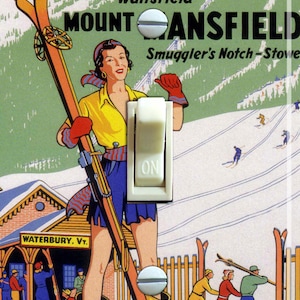 May include: A vintage travel poster advertising Mad River Glen and Mount Mansfield ski resorts in Vermont. The poster features a woman in a yellow sweater and blue skirt holding skis, with a red and white striped scarf. The poster also includes the text "Gateway to Mad River Glen", "Waitsfield", "Mount Mansfield", "Smuggler's Notch-Stowe", "Waterbury, VT.", "Central Vermont Ry.", and "The Ski Lark Route".