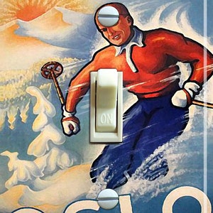 May include: A vintage travel poster for Oslo, Norway, featuring a skier in red and blue clothing, skiing down a snowy mountain. The poster has the text "Winter in Oslo, Norway".