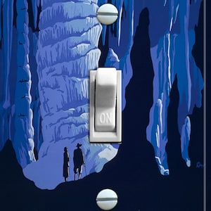 May include: A vintage travel poster with a blue and white color scheme depicting a cave with stalactites and stalagmites. Two figures are standing in the foreground. The poster reads "See America, United States Travel Bureau".
