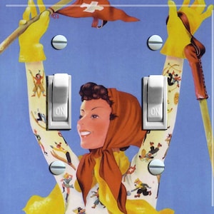 May include: A vintage style light switch cover featuring a woman in a red headscarf and a yellow ski jacket with a Swiss flag on her arm. The woman is smiling and holding a ski pole. The background is blue.