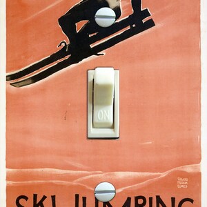 May include: A vintage travel poster advertising ski jumping in Milwaukee and Racine, Wisconsin. The poster features a skier in mid-air, a light switch with the word "ON" printed on it, and the text "SKI JUMPING MILWAUKEE : RACINE NORTH SHORE LINE".