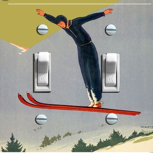 May include: A vintage illustration of a skier in mid-air, jumping off a ski ramp. The skier is wearing a black and white ski suit and a black helmet. The skier is holding two ski poles. The image is set against a light blue background with a light green and yellow sky. The image includes two white light switches with the word "ON" printed on them.