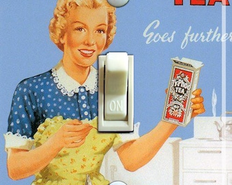 May include: Vintage-style light switch with a retro illustration of a woman holding a box of Ty.Phoo Tea. The image features a tea set on a tray, with the text "Ty.Phoo Tea Goes further" in red and white.
