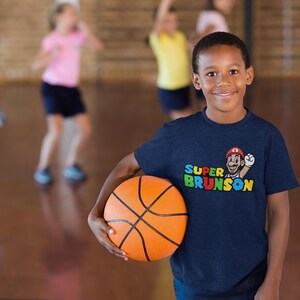 Funny Apparel New York Basketball Super Brunson Fans, Basketball x Video Game Brunson Comic Basketball Sarcastic Funny Adult & Youth T-Shirt