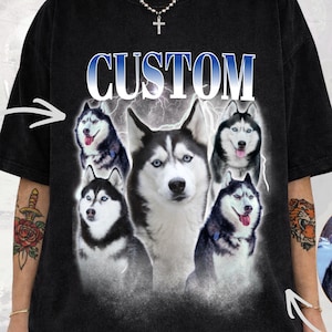 May include: Black t-shirt featuring a graphic of several Siberian Huskies with the word "CUSTOM" in blue and white. The shirt has a vintage wash effect and includes a small logo of a dog.