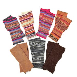 May include: A collection of colorful fingerless gloves with various patterns. Designs include geometric shapes, stripes, and textured knits in shades of pink, orange, blue, brown, and gray. Some gloves are solid colors.