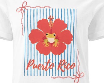 T-shirt featuring a coquí and a maga flower for Puerto Rican women. Feminine design for Boricua women.