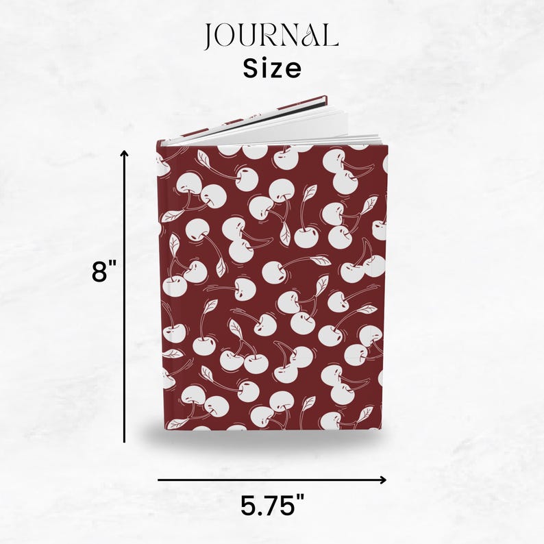 May include: A journal with a cherry pattern on a burgundy background. The journal is 8 inches tall and 5.75 inches wide. The text "JOURNAL Size" is at the top.