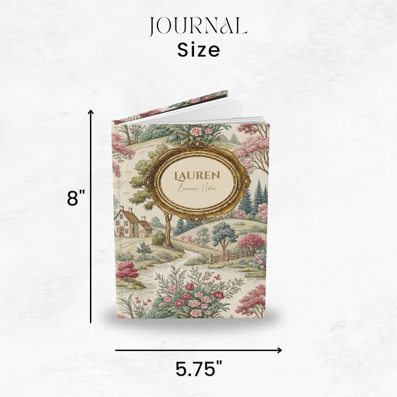 May include: A personalized journal with a landscape design. The journal is 8 inches tall and 5.75 inches wide. The cover features a gold-framed oval with the name "LAUREN" and the words "Business Notes". The journal's cover has a floral and landscape pattern.