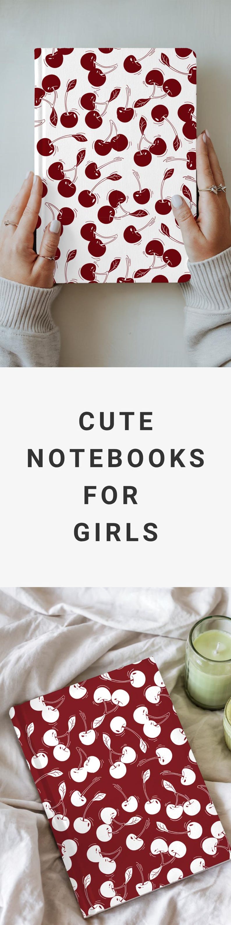 May include: A notebook with a cherry pattern on a white background. The notebook is held by a person. The image also includes the text "CUTE NOTEBOOKS FOR GIRLS".