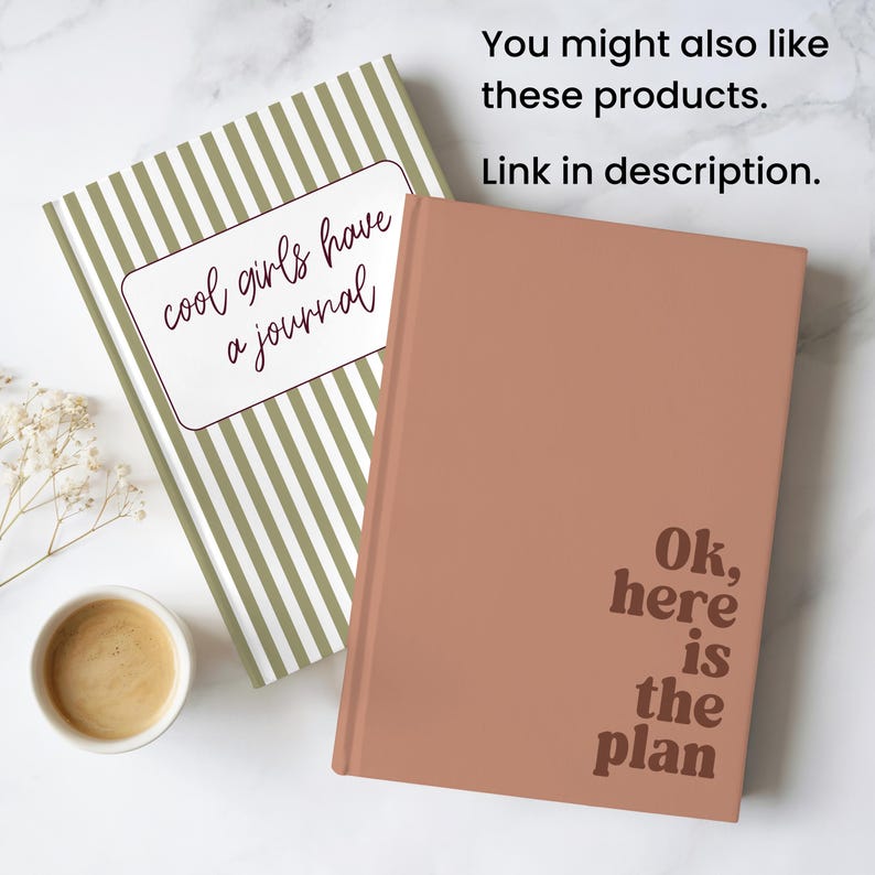 May include: Two journals, one with olive green and white stripes and the text "cool girls have a journal", and a peach-colored journal with the text "Ok, here is the plan". A cup of coffee sits nearby.
