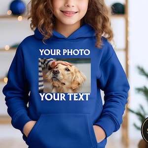 May include: A royal blue hoodie with a front pocket and a hood. The hoodie features a rectangular image of a golden retriever dog with the text "YOUR PHOTO" above and "YOUR TEXT" below. The hoodie is worn by a person.