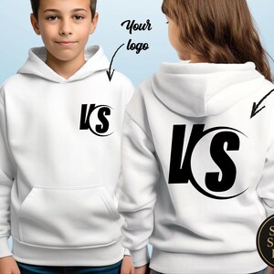 May include: White hooded sweatshirt with a black logo on the front and back. The logo features the letters "VS" in a bold, stylized font. The sweatshirt has a front pocket and a hood.