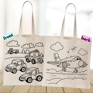 May include: Two canvas tote bags with black line drawings of vehicles and clouds. One bag features cars and trucks, the other an airplane with a moon and stars. The word "front" is on one bag and "back" on the other.