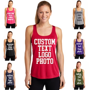 May include: A red tank top with the text "CUSTOM TEXT LOGO PHOTO" in white. The image shows the tank top in various colors, including pink, black, gray, purple, navy, and olive green. The tank tops are sleeveless.