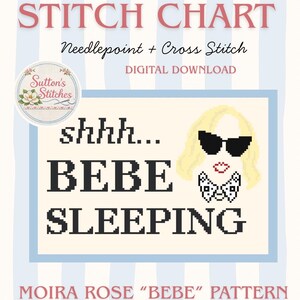 May include: A digital cross-stitch chart with the text "STITCH CHART" in pink. The design includes the words "shhh... BEBE SLEEPING" in black pixelated letters, and a cartoon image of a woman with sunglasses. The chart is a "MOIRA ROSE 'BEBE' PATTERN".