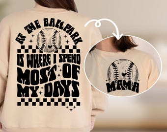 May include: Tan sweatshirt with black text that reads "At the ballpark is where I spend most of my days" with a baseball graphic. The back of the sweatshirt has a baseball graphic with the word "Mama" underneath.