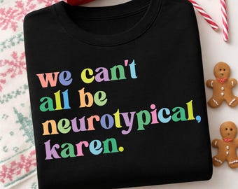 Könnte beinhalten: Schwarzes Sweatshirt mit Rundhalsausschnitt und dem Text "we can't all be neurotypical, karen" in Regenbogenfarben. Das Sweatshirt ist von Weihnachtsdekorationen umgeben, darunter Lebkuchenmänner und Zuckerstangen.