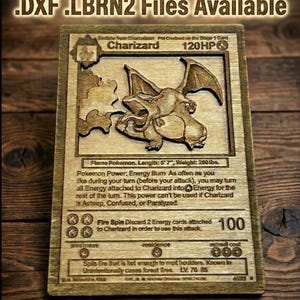 May include: Wooden laser-cut Charizard Pokémon card. The card features a detailed relief of Charizard, with text including "Charizard 120HP" and "Flame Pokemon." The top of the image reads "LightBurn Ready .SVG .AI .DXF .LBRN2 Files Available."