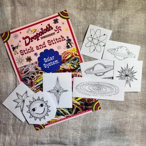 May include: A set of embroidery patterns for a solar system themed project. The patterns include a sun, planets, stars, and a galaxy. The patterns are printed on white cardstock and are ready to be stitched.