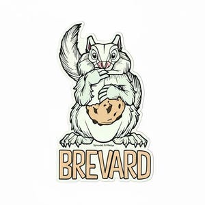 May include: A die-cut sticker featuring a white squirrel with black outlines holding a tan chocolate chip cookie. The squirrel has a bushy tail and is positioned above the text BREVARD in large tan letters with black outlines on a white background.