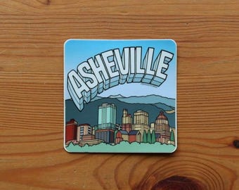 Asheville Souvenir VEHICLE SIZED Sticker | Blue Ridge Mountains with City Buildings | Length 3.5 Inches