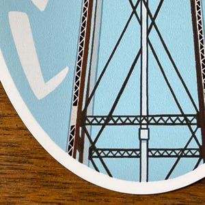 May include: A blue and white sticker with a black and brown illustration of a water tower. The sticker has the text "SPROUTED SCRIBBLES" on the right side.