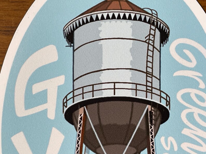 May include: A blue and white sticker featuring a white water tower and the text "Green's" in white.