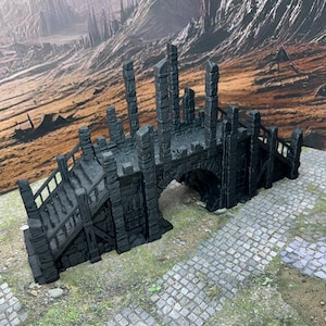 May include: A dark grey, stone bridge with a set of stairs leading up to it. The bridge is arched and has a rough, textured surface. The bridge is set against a backdrop of a rocky, barren landscape.