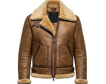 Puede incluir: Chaqueta de cuero marrón con cuello y forro de borrego. La chaqueta presenta una cremallera, dos bolsillos delanteros y detalles de hebilla en la cintura y el cuello. Estilo aviador clásico.