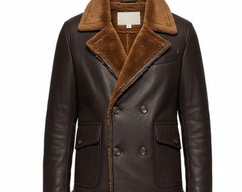 May include: A brown leather jacket with a shearling collar and lining. The double-breasted jacket has two front pockets and two rows of buttons. The shearling is a light brown color, and the leather is a darker brown.