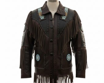 May include: Brown leather jacket with fringe detailing, turquoise and gold beadwork, and decorative stitching. The jacket features a notched collar, button closure, and fringe along the sleeves, chest, and back. The jacket is displayed on a mannequin.