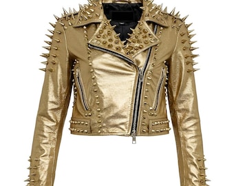 May include: A gold-colored, metallic-looking jacket with a black collar and zipper. The jacket is covered in gold-colored spikes on the shoulders, collar, and sleeves. The jacket has a classic biker jacket design with a diagonal zipper.