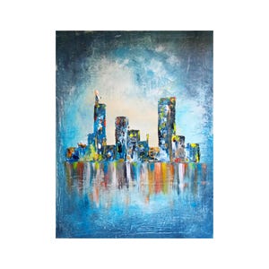 May include: Abstract cityscape painting with a textured, impasto style. The artwork depicts a skyline with colorful buildings reflected in water. Dominant colors include blues, yellows, and reds, creating a vibrant and dynamic composition.