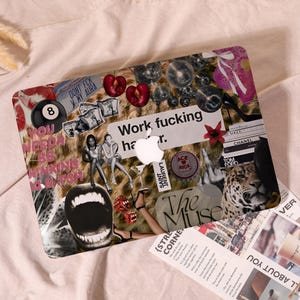 May include: A laptop skin featuring a collage of images including cherries, disco balls, a black billiard ball with the number 8, a leopard, a high-heeled shoe, and text that reads "Work fucking harder" and "YOU NEEDA BE THINKING B*TCH".