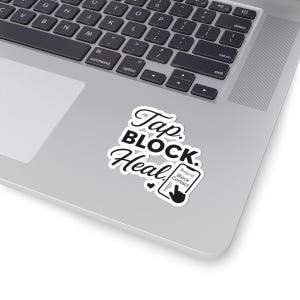 May include: A white sticker with black text that reads "Tap. BLOCK. Heal." A small graphic of a phone with a hand blocking a contact is also included. The sticker is placed on a silver laptop.