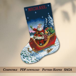 May include: A Christmas stocking cross-stitch pattern featuring Santa Claus in a red sleigh filled with gifts, pulled through a snowy landscape. The name MICHAEL is stitched in red at the top against a dark blue night sky with stars.