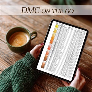 May include: A digital tablet displaying a DMC color chart, held by a person wearing a green sweater. A green mug of coffee sits on a wooden table. The text "DMC ON THE GO" is at the top of the image.