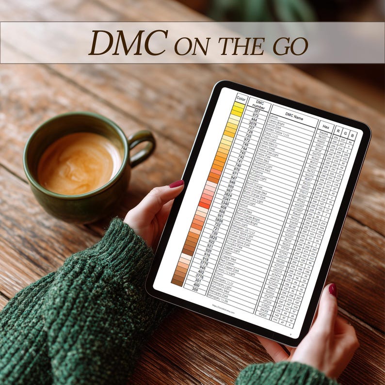May include: A digital tablet displaying a DMC color chart, held by a person wearing a green sweater. A green mug of coffee sits on a wooden table. The text "DMC ON THE GO" is at the top of the image.