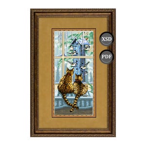 May include: Framed artwork featuring two cats with spotted fur, gazing out a window at a birdhouse and birds in a snowy scene. The artwork is in a gold frame, with the text "XSD" and "PDF" on the right side.