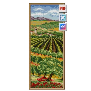 May include: A cross-stitch landscape depicting a vineyard with rows of grapevines, trees, and a village with a church tower. The sky is blue with white clouds, and the foreground features red flowers. The artwork is framed in a gold border.