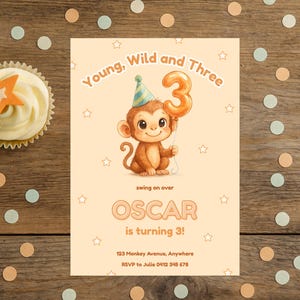 May include: A birthday invitation with a cartoon monkey holding a number three balloon. The text reads "Young, Wild and Three" and "Oscar is turning 3!". A cupcake with an orange star and confetti are on a wooden surface.