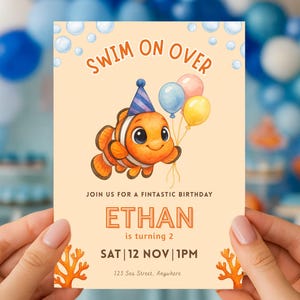 May include: A birthday invitation featuring a cartoon clownfish holding balloons. The invitation reads "Swim on Over" and includes the name "Ethan" and the date "12 Nov". The invitation has a light orange background with coral illustrations.