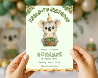 May include: A birthday invitation featuring a watercolor illustration of a koala wearing a party hat and holding a cake with a lit candle. The text reads "KOALA-TY BIRTHDAY" and invites guests to celebrate Roxanne's third birthday.