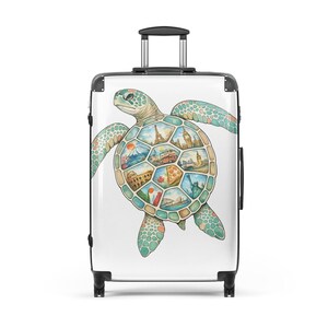 May include: A white rolling suitcase featuring a watercolor illustration of a sea turtle. The turtle's shell is filled with iconic landmarks from around the world, including the Eiffel Tower and the Statue of Liberty. The turtle is in shades of green and blue.