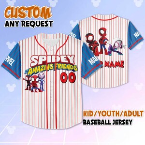 May include: White and red pinstripe baseball jersey with blue sleeves. The jersey features the text "SPIDEY AMAZING FRIENDS" and the number "00". The sleeves have "MARVEL" printed on them. The jersey is customizable and available in kid, youth, and adult sizes.
