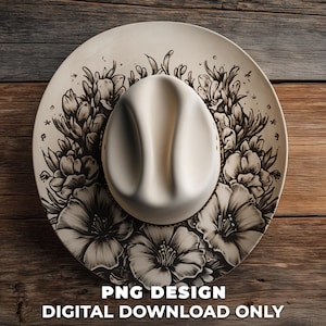 May include: A cream-coloured cowboy hat with a floral design. The hat is centered on a wooden surface. The brim of the hat is decorated with black and white floral illustrations. The text "PNG DESIGN DIGITAL DOWNLOAD ONLY" is at the bottom.