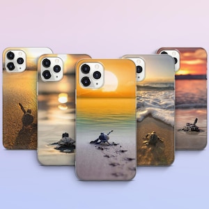 May include: A collection of phone cases featuring a sunset beach scene with baby sea turtles. The cases display a vibrant orange and yellow sky, golden sand, and gentle waves. Each case showcases a different perspective of the beach.
